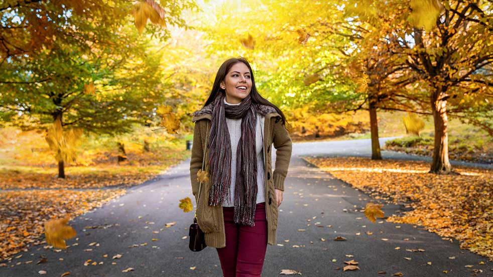 Best autumn walks in the UK woman smiling in autumn